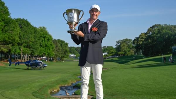 Rory McIlroy poses with his winner's trophy and Wells Fargo Champio<em></em>nship jacket