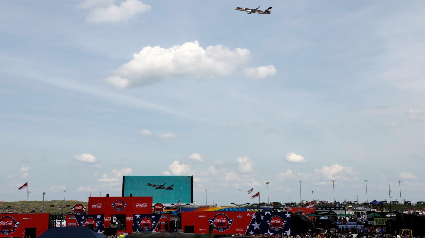 Former President Do<em></em>nald Trump's jet flies over the crowd before he attends the NASCAR Coca-Cola 600 auto race, Sunday, May 26, 2024, in Concord, N.C. It is the first time that a president or former president has attended a race at Charlotte Motor Speedway. (AP Photo/Chris Seward)