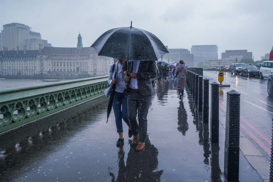 Mandatory Credit: Photo by Amer Ghazzal/Shutterstock (14496807s) Pedestrians on Westminster Bridge brave the heavy rain showers . A warning for thunderstorms in Lo<em></em>ndon and the South East has been issued Seaso<em></em>nal Weather, Westminster, London, United Kingdom - 22 May 2024