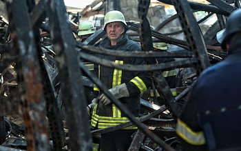 Firefighters remove rubble after a Russian attack on May 27