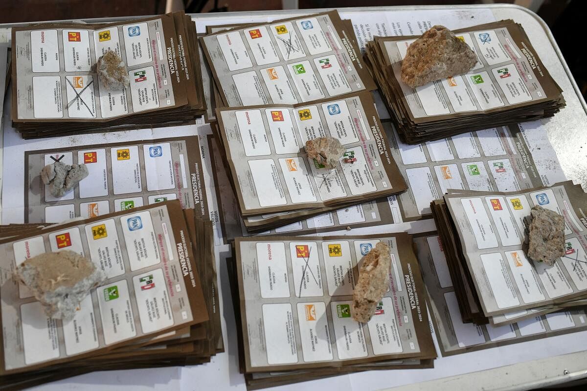 Stacks of ballots are held down with rocks during the vote count at a polling station after polls closed on the day of general elections, in Veracruz, Mexico.