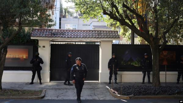 FILE - Mexican police stand guard outside the Ecuadorian Embassy, in Mexico City, April 6, 2024. 