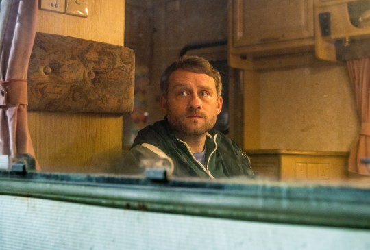 Paul looks out of the window of an old motorhome in Corrie