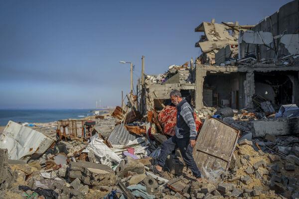 A Palestinian man walks in the rubble of destroyed buildings in Gaza City on Wednesday. Picture: AP Photo/Mohammed Hajjar