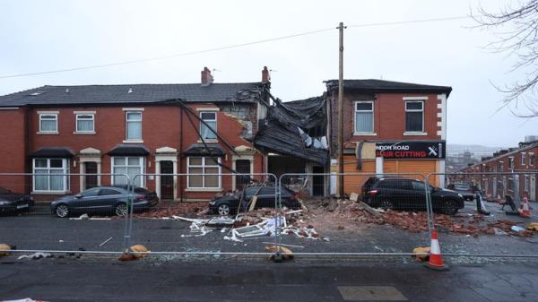 Debris litters the road and pavement in Lo<em></em>ndon Road, Blackburn, Lancashire, wher<em></em>e a property collapsed just before 8pm on Sunday after an issue with gas triggered an explosion. Two people were taken to hospital and nearby properties have been evacuated. Picture date: Mo<em></em>nday December 18, 2023. PA Photo. See PA story POLICE Blackburn. Photo credit should read: Paul Currie/PA Wire