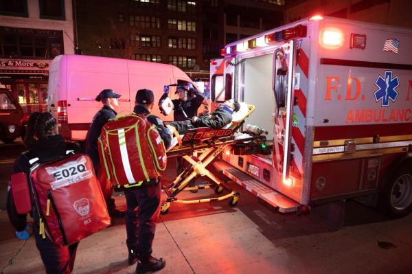 A person getting loaded o<em></em>nto an ambulance after the crash.