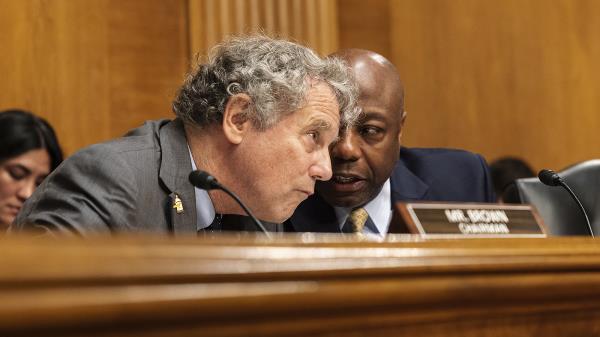 Sen. Tim Scott (R-S.C.) speaks to Sen. Sherrod Brown (D-Ohio)