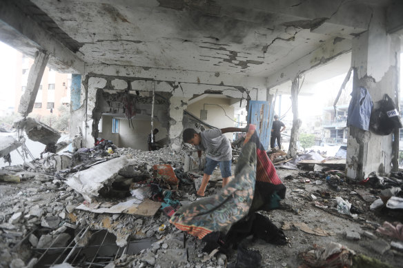 Palestinians look at the aftermath of the Israeli strike on a UN-run school that killed dozens of people in the Nusseirat refugee camp in the Gaza Strip.