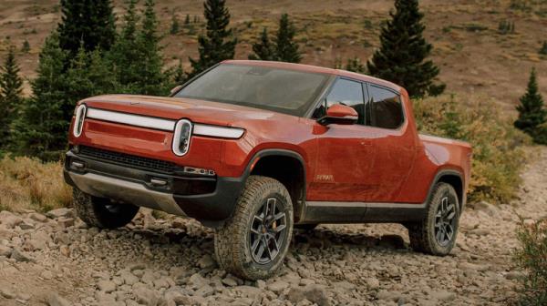 red Rivian truck on off-road trail