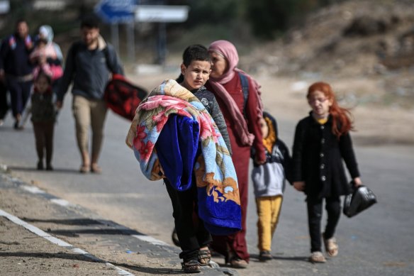 Displaced Palestinians walk along the Salah al-Din road towards the southern Gaza Strip in November. The UN estimates more than 80% of the Gazan population of 2.3 million are displaced.