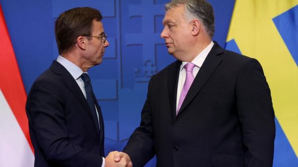 Ulf Kristersson and Viktor Orban shake hands in Budapest on Friday, 23 February 2024. Pic: Reuters