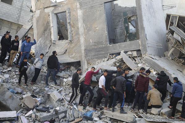 Palestinians look for survivors of the Israeli bombardment of the Gaza Strip in Rafah, Sunday, Dec. 3, 2023. (AP Photo/Hatem Ali)