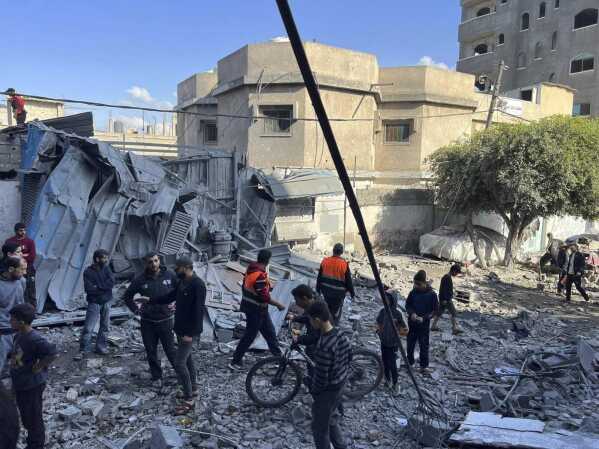 People look at a home that was destroyed by an Israeli airstrike on Dec. 6, 2023, in Nuseirat refugee camp in the Gaza Strip. Four-year-old Omar Abu Kawaik was pulled alive from the rubble and brought out of Gaza then flown to the United States, wher<em></em>e he received treatment including a prosthetic arm. (Courtesy of Maha Abu Kuwaik via AP)