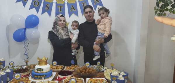 This undated photo, provided by Maha Abu Kuwaik, shows the family of 4-year-old Omar Abu Kuwaik at the Bureij refugee camp in Gaza. From left, are Omar's mother Azhaar Atef Aboul Eish, Omar, his father, Hazem Abu Kuwaik, and sister, Yasmeen Abu Kuwaik. On Dec. 6, 2023, Omar's parents and sister were killed in an Israeli airstrike. (Maha Abu Kuwaik via AP)