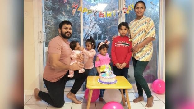 A family of six, with an older man on the right followed by three young daughters, a son and a mother.