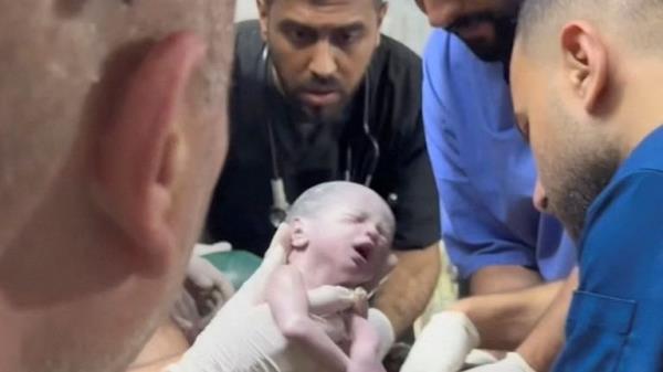 A medic holds a Palestinian newborn girl after she was pulled alive from the womb of her mother Sabreen Al-Sheikh (Al-Sakani), who was killed in an Israeli strike, along with her husband Shokri and her daughter Malak, amid the o<em></em>ngoing co<em></em>nflict between Israel and the Palestinian Islamist group Hamas, at a hospital in Rafah in the southern Gaza Strip, in this still image taken from a video recorded April 20, 2024. Reuters TV via REUTERS