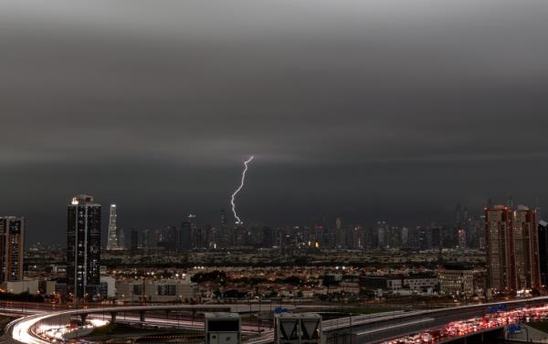 A lightning flashes through the sky during a heavy rainfall in Dubai, United Arab Emirates, 16 April 2024. A severe wave of thunderstorms with heavy rainfall is hitting most UAE's cities especially in Dubai, Sharjah and Al Ain wher<em></em>e the Asian Champions League semi final first leg match between UAE's Al-Ain Club and Al-Hilal from Saudi Arabia has been postponed. 