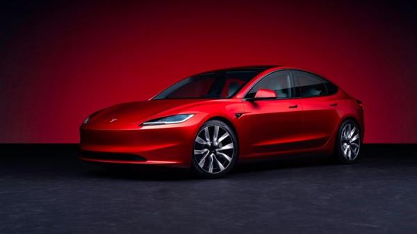 Tesla Model 3 facelift: front three quarter view, red paint, studio shoot