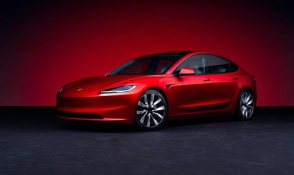 Tesla Model 3 facelift: front three quarter view, red paint, studio shoot