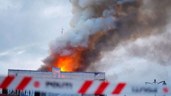 Smoke billows during a fire at the Old Stock Exchange, Boersen, in Copenhagen, Denmark.</p>

<p>　　Pic: Reuters