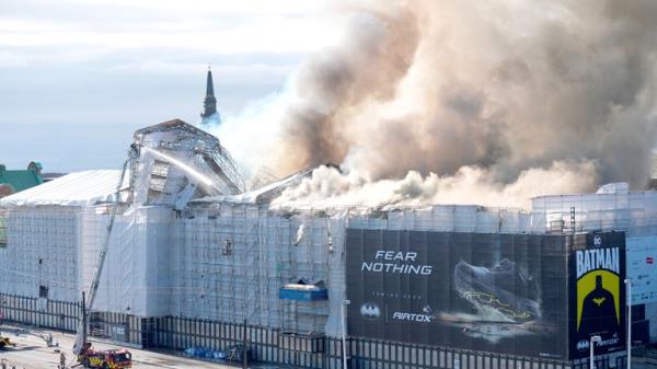 Smoke billows during a fire at the Old Stock Exchange, Boersen, in Copenhagen.</p>

<p>　　Pic: Reuters