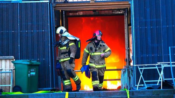 Firefighters walk out of the main entrance as the Old Stock Exchange burns in Copenhagen, Denmark.</p>

<p>　　Pic: Scanpix/AP