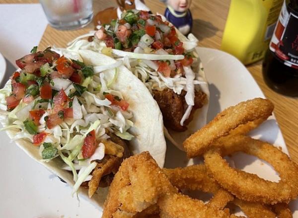 fish tacos and o<em></em>nion rings on a plate.