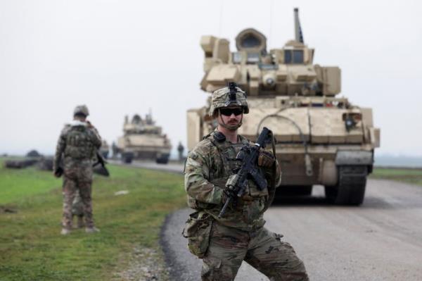 A soldier from the US-led coalition stands guard during a joint U.S.- Kurdish-led Syrian Democratic Forces (SDF) patrol in the countryside of Qamishli in northeastern Syria February 8, 2024.