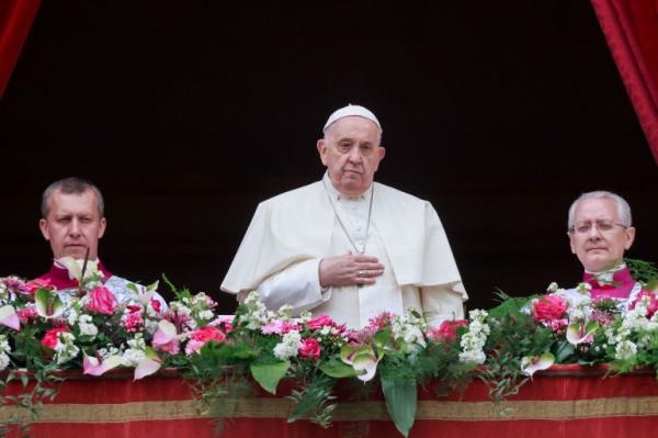 Pope Francis looks on from a balcony, on the day he delivers his 