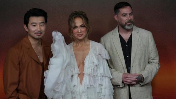 Simu Liu, left, Jennifer Lopez, center, and Brad Peyton pose for photos in a promotio<em></em>nal event for Netflix series ATLAS in Mexico City, Tuesday, May 21, 2024. (AP Photo/Marco Ugarte)