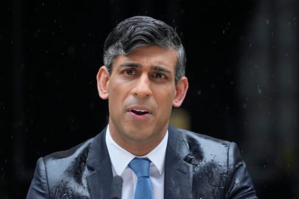 Britain's Prime Minister Rishi Sunak speaks to the media, as heavy rain falls, outside 10 Downing Street in Lo<em></em>ndon Wednesday,