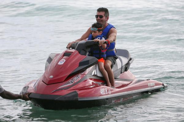 Simon Cowell is seen jet skiing with his son Eric on December 18, 2019 in Bridgetown, Barbados.