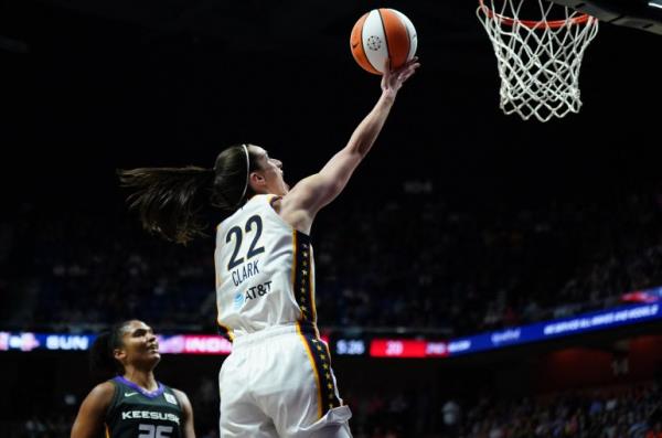 May 14, 2024; Uncasville, Connecticut, USA; Indiana Fever guard Caitlin Clark (22) scores her first regular season basket against the Co<em></em>nnecticut Sun in the second quarter at Mohegan Sun Arena. Mandatory Credit: David Butler II-USA TODAY Sports