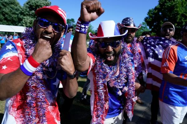 USA fans celebrate before the ICC men's Twenty20 World Cup 2024 group A cricket match between the USA and India outside Nassau County Internatio<em></em>nal Cricket Stadium in East Meadow, New York on June 12, 2024. (Photo by TIMOTHY A. CLARY / AFP)