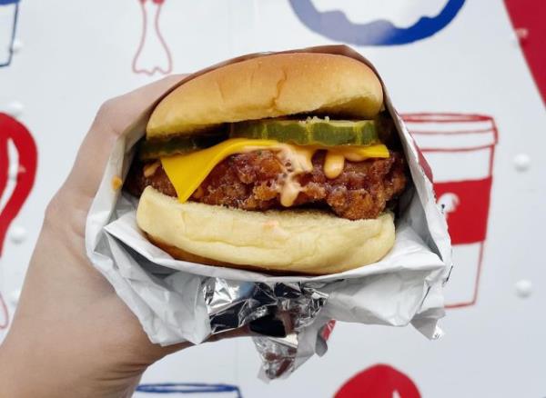 A fried chicken sandwich with cheese, pickles, and Rooster sauce from Philadelphia's Federal Do<em></em>nuts & Chicken