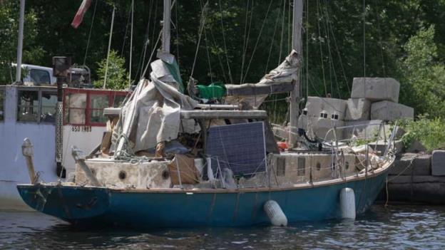 A tattered-looking sailboat.