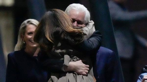 WikiLeaks founder Julian Assange embraces his wife Stella after landing at RAAF air ba<em></em>se Fairbairn in Canberra, Australia, Wednesday, June 26 2024. Assange has returned to his homeland Australia aboard a charter jet hours after pleading guilty to obtaining and publishing U.S. military secrets in a deal with Justice Department prosecutors that co<em></em>ncludes a drawn-out legal saga.(AP Photo/Rick Rycroft)