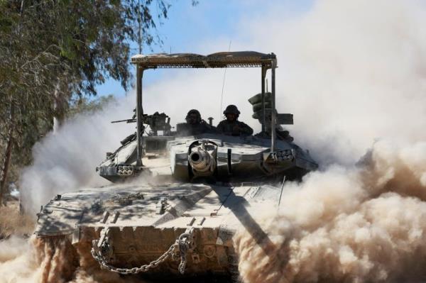 An Israeli tank manoeuvres near the Israel-Gaza border