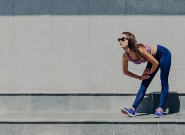 woman stretching outdoors after walk