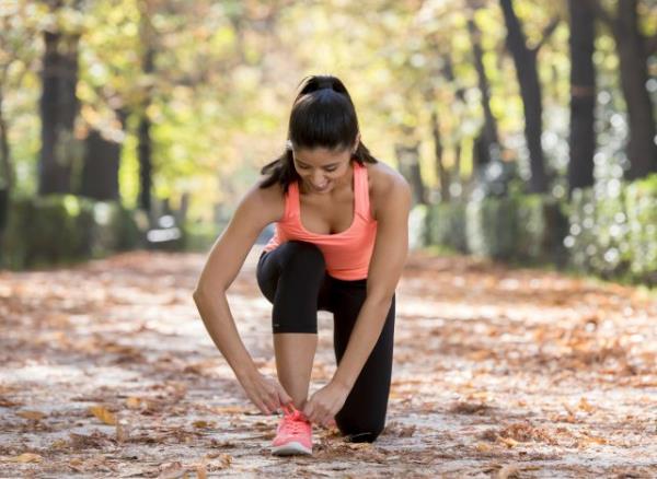 female runner tying her sneakers