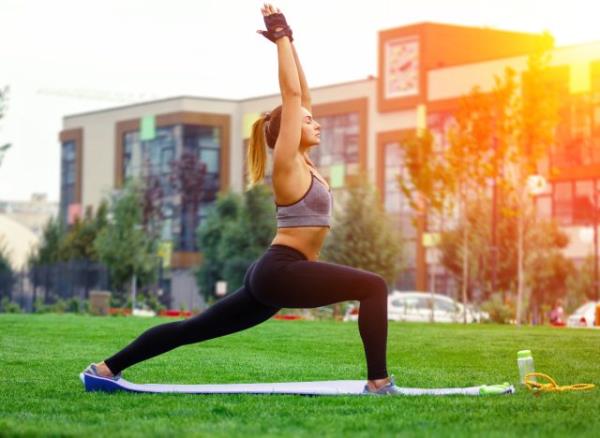 woman doing yoga lunge, co<em></em>ncept of the best exercises for a strong pelvic floor