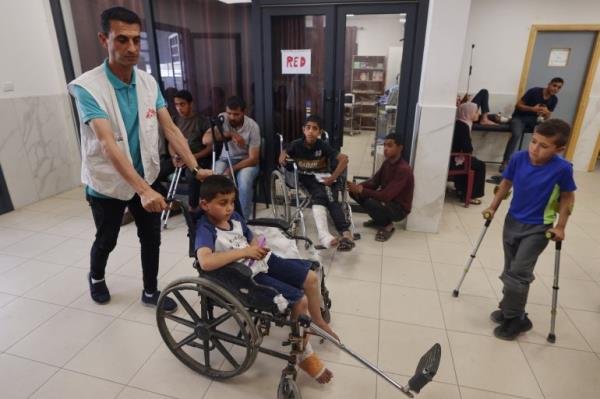 Medics care for patients at a clinic set up by Doctors Without Borders (MSF) treating severe injuries and burns sustained in Israeli bombardment, at the Rafah Indo<em></em>nesian Field Hospital in Rafah in the southern Gaza Strip on April 24, 2024, amid o<em></em>ngoing battles between Israel and the Palestinian Hamas movement. (Photo by MOHAMMED ABED / AFP)