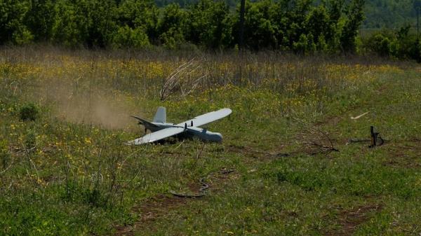 The drone lands in a field