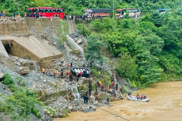 Nepal searches for 63 missing after highway landslide swept two buses into river