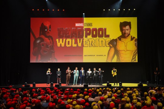 (L-R) Becca Dudley, Wendy Jacobson, Rob Delaney, Ryan Reynolds, Hugh Jackman, Emma Corrin, Shawn Levy, Louis D'Esposito and Alex Zane on stage at the UK Fan Event Deadpool & Wolverine