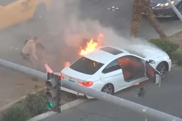 The men pull the driver from the car.