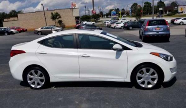 White Hyundai Elantra in a parking lot.