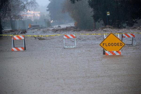 A flooded street in Mo<em></em>ntecito due to the San Ysidro creek overflowing.