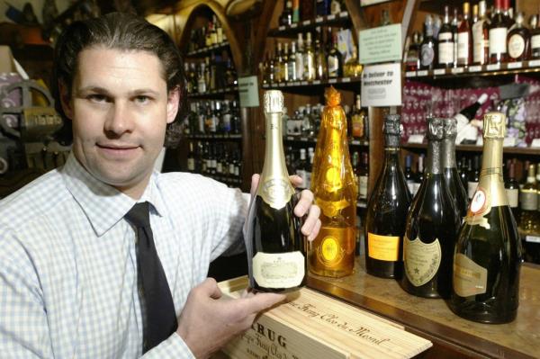 Shyda Gilmer displaying a bottle of champagne.