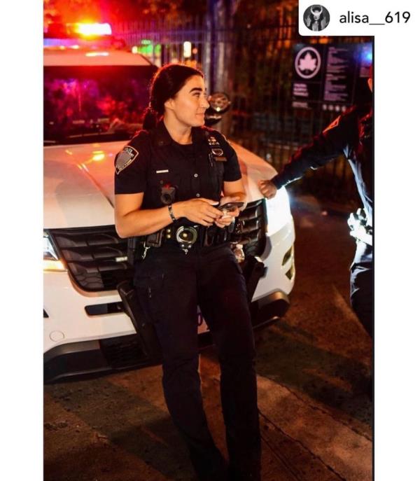 Alisa Bajraktarevic, 33, standing outside police cruiser.